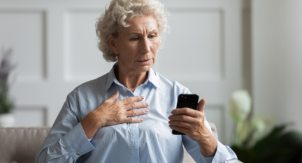 A mature woman using a payment app on her mobile phone